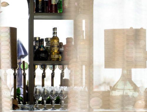 liquor bottles behind curtain in bar in Wynyard Quarter
