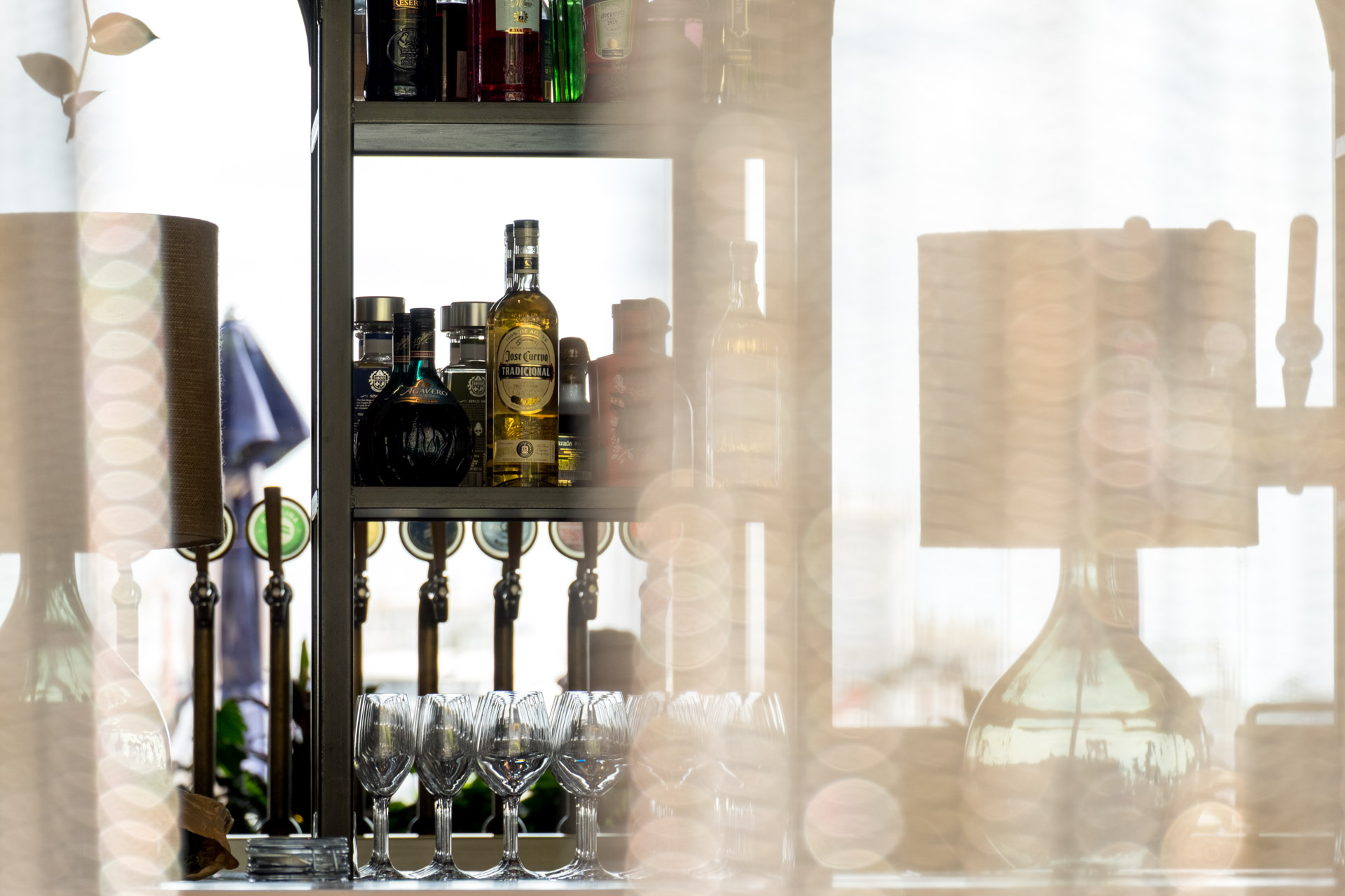 liquor bottles behind curtain in bar in Wynyard Quarter